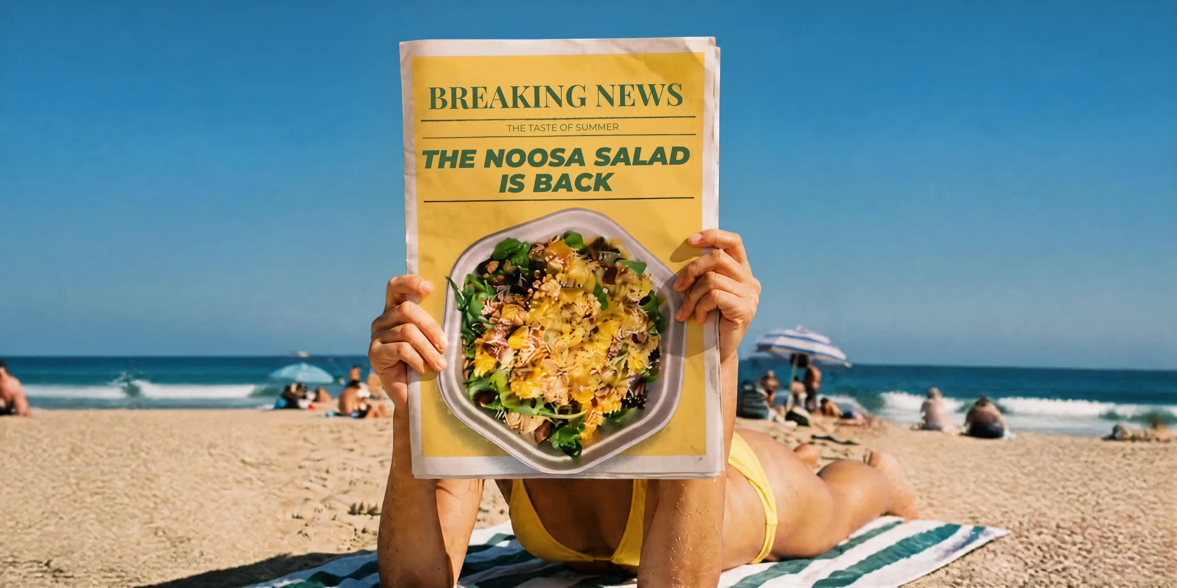 Beachgoer reading a newspaper headlined: The Noosa Salad is back